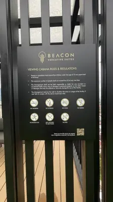 a sign on a glass door of a room with clocks at Beacon Executive Suites #Georgetown #InfinityPool #15 in George Town
