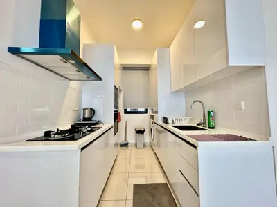 a kitchen with white cabinets and a stove top oven at Beacon Executive Suites #Georgetown #InfinityPool #15 in George Town