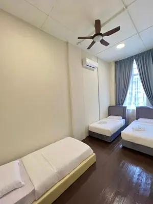 a room with two beds and a ceiling fan at The Neighbour KKB - Rooms with shared bathroom - Whole unit has 4 rooms in Kuala Kubu Baharu