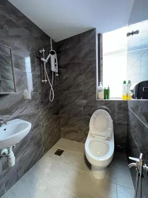 a bathroom with a toilet and a sink at The Neighbour KKB - Rooms with shared bathroom - Whole unit has 4 rooms in Kuala Kubu Baharu