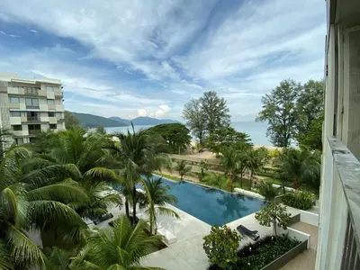 a view of the pool from the balcony of a hotel at BY THE SEA - Penthouse 3 bedroom in Batu Ferringhi