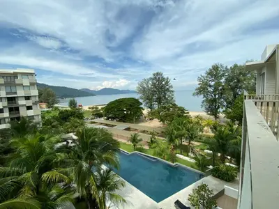 a view from the balcony of a resort with a swimming pool at BY THE SEA - Penthouse 3 bedroom in Batu Ferringhi