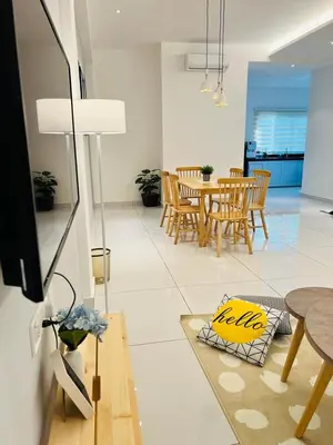 a living room with a table and chairs at Inn Homestay in Teluk Intan
