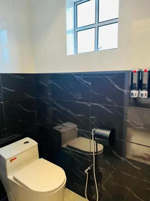 a bathroom with a toilet and a window at Inn Homestay in Teluk Intan