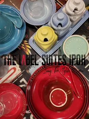 a group of different colored plates on a table at The Label Suites Ipoh in Ipoh