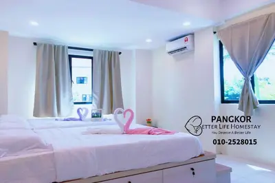 a bedroom with two beds with pink swans on them at Better Life Apartment near beach-2room 2bathroom 6pax in Pangkor