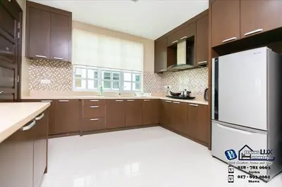 a kitchen with wooden cabinets and a white refrigerator at Tanjung Bungah 6BR 20Pax Bungalow w/ Snooker BBQ in Tanjung Bungah
