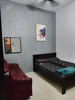 a bedroom with a bed and a chair at YMT Tambun The Lost World Hideaway in Ipoh