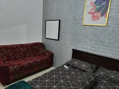 a living room with a couch and a bed at YMT Tambun The Lost World Hideaway in Ipoh