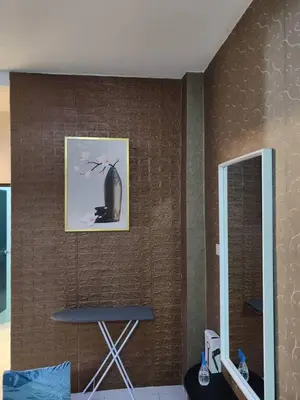a wall with a picture and a chair in a room at YMT Tambun The Lost World Hideaway in Ipoh