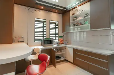 a kitchen with a white counter and a red chair at Qua Homestay 5 Rooms 6 Bathrooms in Taiping