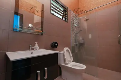 a bathroom with a toilet and a sink and a shower at Qua Homestay 5 Rooms 6 Bathrooms in Taiping
