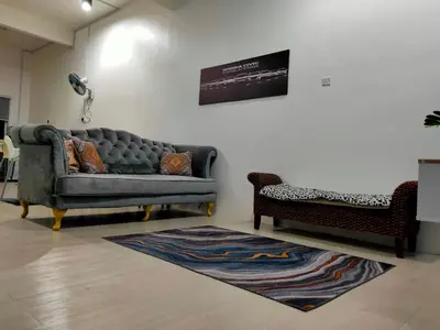 a living room with a couch and a chair at SALAM Homestay D'Gerik in Gerik