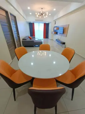 a white table and chairs in a living room at Joyful Sitiawan skygarden swimming pool in Seri Manjung