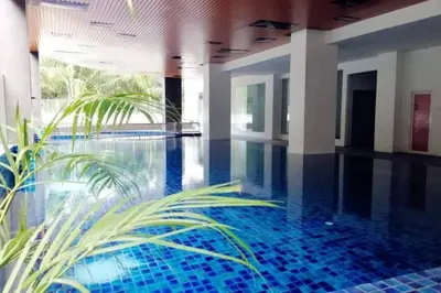 a swimming pool with blue tiles in a building at Joyful Sitiawan skygarden swimming pool in Seri Manjung