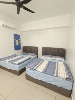 two beds in a room with a ceiling fan at Joyful Sitiawan skygarden swimming pool in Seri Manjung
