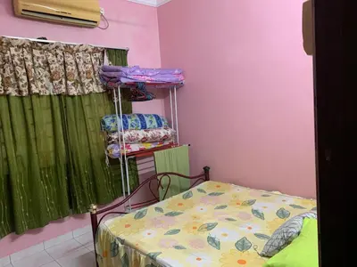 a small room with a bed and a window at D’baroh Homestay in Kampong Tanjong Karang
