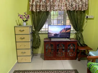 a room with a desk with a laptop computer on it at D’baroh Homestay in Kampong Tanjong Karang