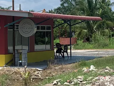 a bus stop with a bench in front of it at D’baroh Homestay in Kampong Tanjong Karang