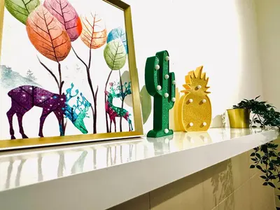 a shelf with a picture and plants on it at Nordic Home Falim 31 Astro in Ipoh