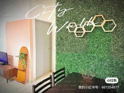 a green wall with a bench in front of a building at Nordic Home Falim 31 Astro in Ipoh