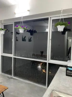 a room with a large window with potted plants at SmileHome at Cameron Brinchang - KEA FARM in Brinchang