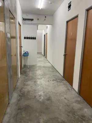 an empty hallway with a row of doors and a table at SmileHome at Cameron Brinchang - KEA FARM in Brinchang