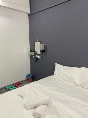 a white bed with a pair of scissors on it at SmileHome at Cameron Brinchang - KEA FARM in Brinchang
