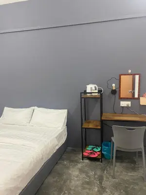 a bedroom with a bed and a desk with a mirror at SmileHome at Cameron Brinchang - KEA FARM in Brinchang