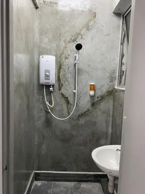 a bathroom with a sink and a soap dispenser on the wall at SmileHome at Cameron Brinchang - KEA FARM in Brinchang