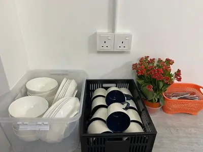 a black container filled with plates and bowls at SmileHome at Cameron Brinchang - KEA FARM in Brinchang