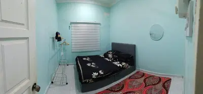 a bedroom with a bed in a blue room at Casa Indera in Kampung Bota Kiri