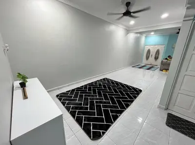 a living room with a black and white rug on the floor at Casa Indera in Kampung Bota Kiri