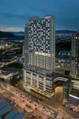 a large tall building with traffic in a city at LOVELY 2ROOM SUITE6PAX@SKY CONDO JURU SENTRAL in Bukit Mertajam