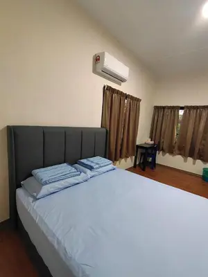 a bedroom with a large bed with a air conditioner at CLP perai homestay near Sri Muniswarar Temple 2 in Perai