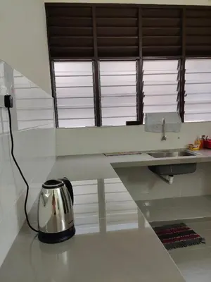 a tea kettle sitting on a counter in a kitchen at CLP perai homestay near Sri Muniswarar Temple 2 in Perai