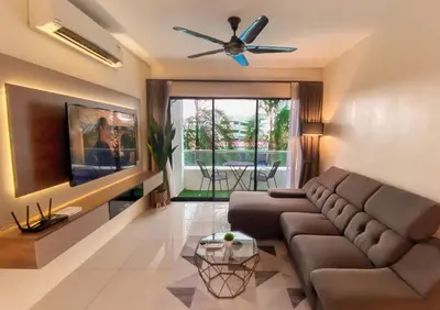 a living room with a couch and a ceiling fan at Comfy Suite Manhattan Ipoh PoolView Waterpark Free Netflix&Game in Ipoh