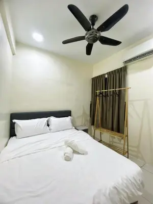 a bedroom with a white bed with a ceiling fan at Comfy Suite Manhattan Ipoh PoolView Waterpark Free Netflix&Game in Ipoh
