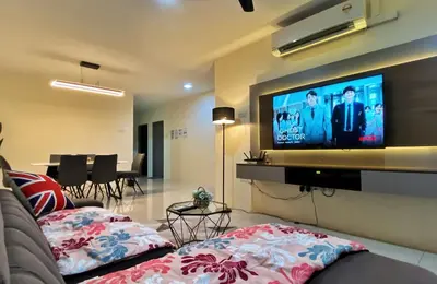 a living room with a couch and a flat screen tv at Comfy Suite Manhattan Ipoh PoolView Waterpark Free Netflix&Game in Ipoh