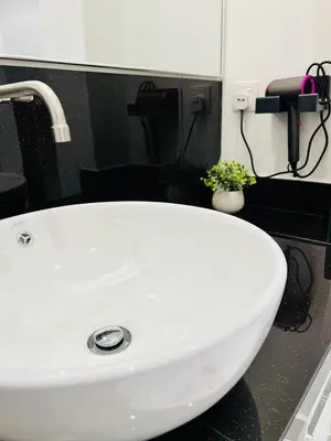 a white sink in a bathroom at Inn Homestay 1st Floor Unit in Teluk Intan