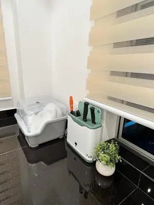 a room with a table with a cooler and a plant at Inn Homestay 1st Floor Unit in Teluk Intan