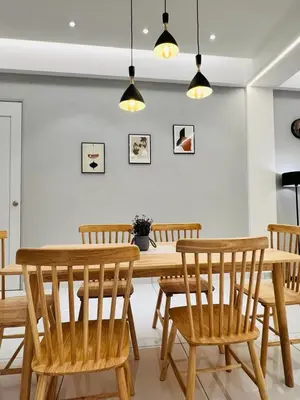 a dining room with a wooden table and chairs at Inn Homestay 1st Floor Unit in Teluk Intan