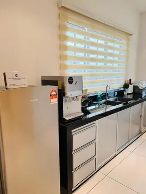 a kitchen with a sink and a counter top at Inn Homestay 1st Floor Unit in Teluk Intan