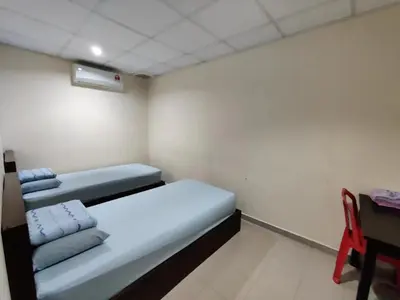 a room with a bed and a desk and a chair at CLP perai homstay in perai in Perai