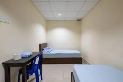 a room with a bed and a desk and a table at CLP perai homstay in perai in Perai