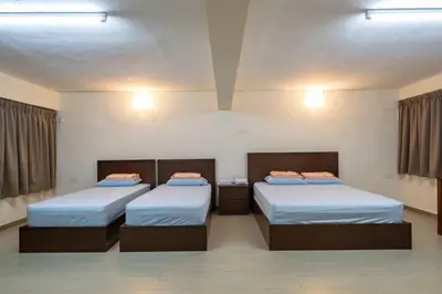 a room with two beds and two night stands at CLP perai homstay in perai in Perai