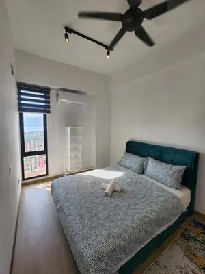 a bedroom with a large bed with a ceiling fan at Praicon Executive Suite in Butterworth