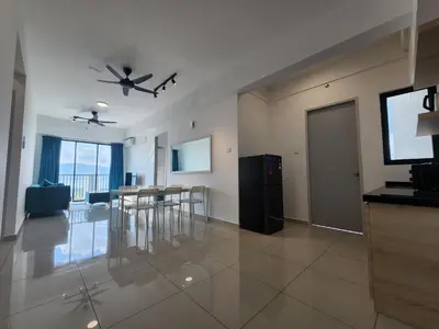 a living room with a dining table and a television at Praicon Executive Suite in Butterworth