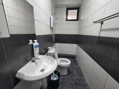 a bathroom with a sink and a toilet at Praicon Executive Suite in Butterworth