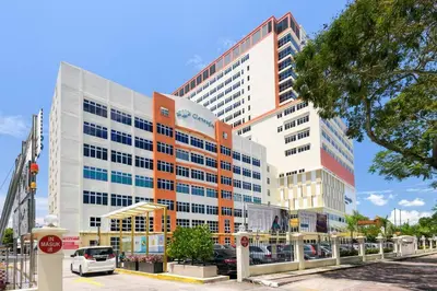 a large office building in front of a street at 2R2B/Harmony Sunrise/1~8pax/Gurney/Mansion One in George Town